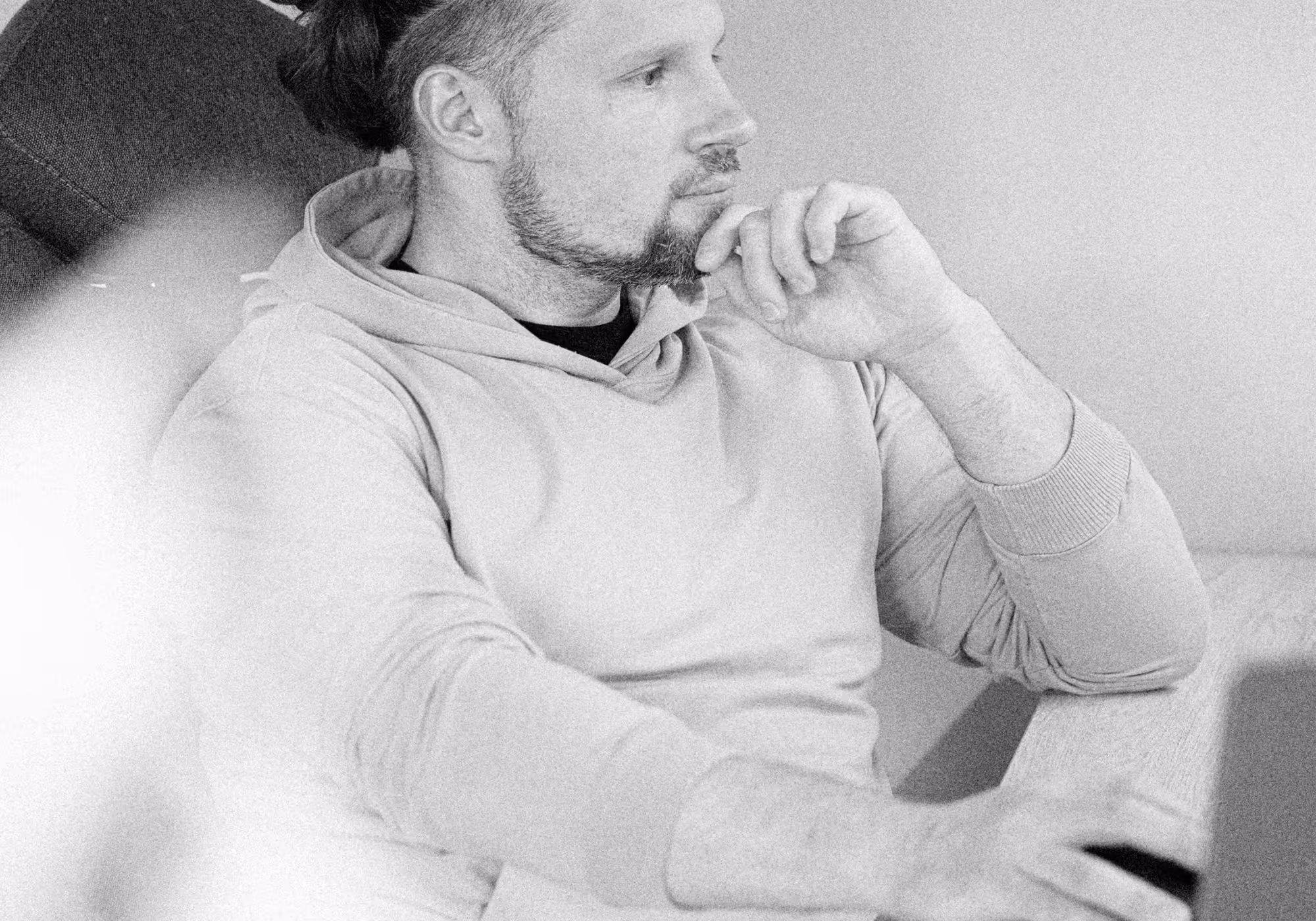 Black-and-white portrait of Victor Vorontsov at his desk, beard and hair in a bun, hand on his chin while working